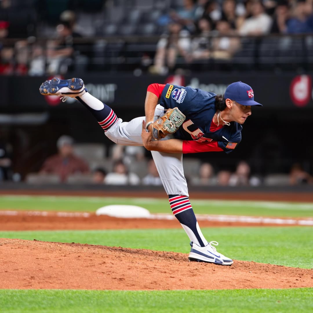 Ricky Ojeda, dressed in the USA National team uniform, delivers a pitch.